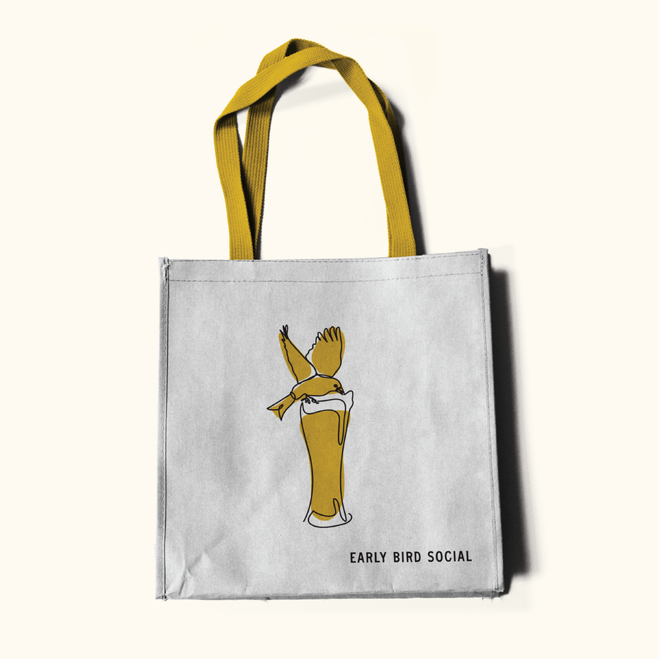 tote bag with illustration of bird drinking out of glass